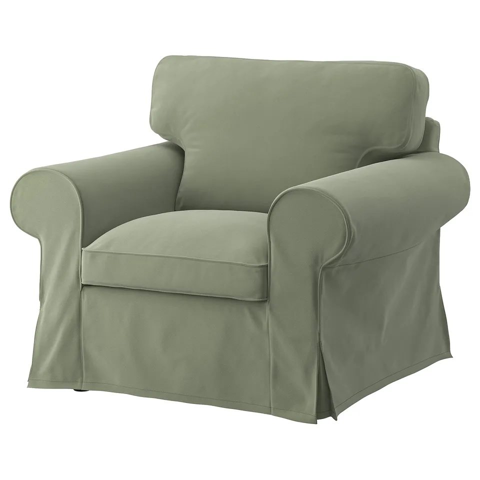 Sage green EKTORP armchair, soft fabric, rolled arms, clean lines.