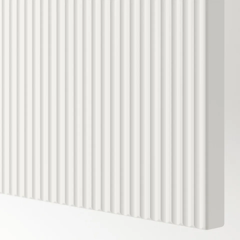 Close-up of sleek, modern white drawer front with elegant fluted texture.