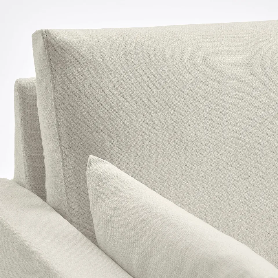 Light, modern sofa in neutral tone. Clean, sleek lines and inviting cushions. High-quality fabric and stitching.