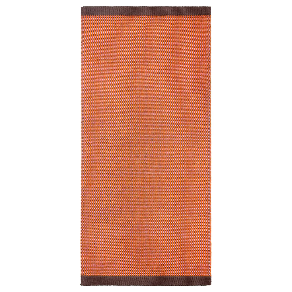 An orange and brown grid-patterned rectangular VÄGOMRÅDE cotton rug.