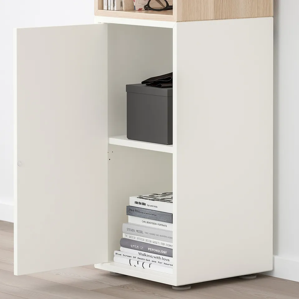 EKET storage unit with open/closed compartments, books, & push-opener door.