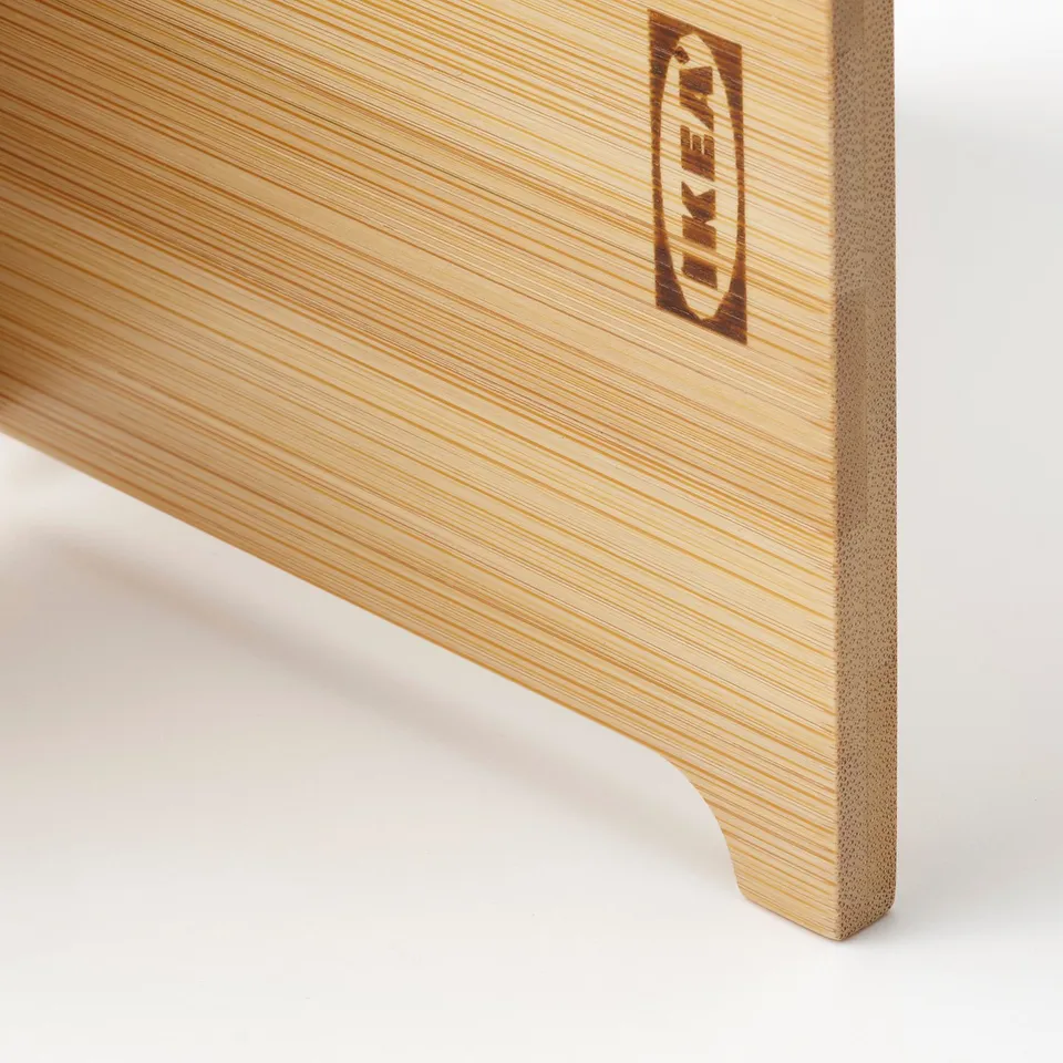 Close-up of bamboo stands edge, showing smooth finish and light grain, with brand label.