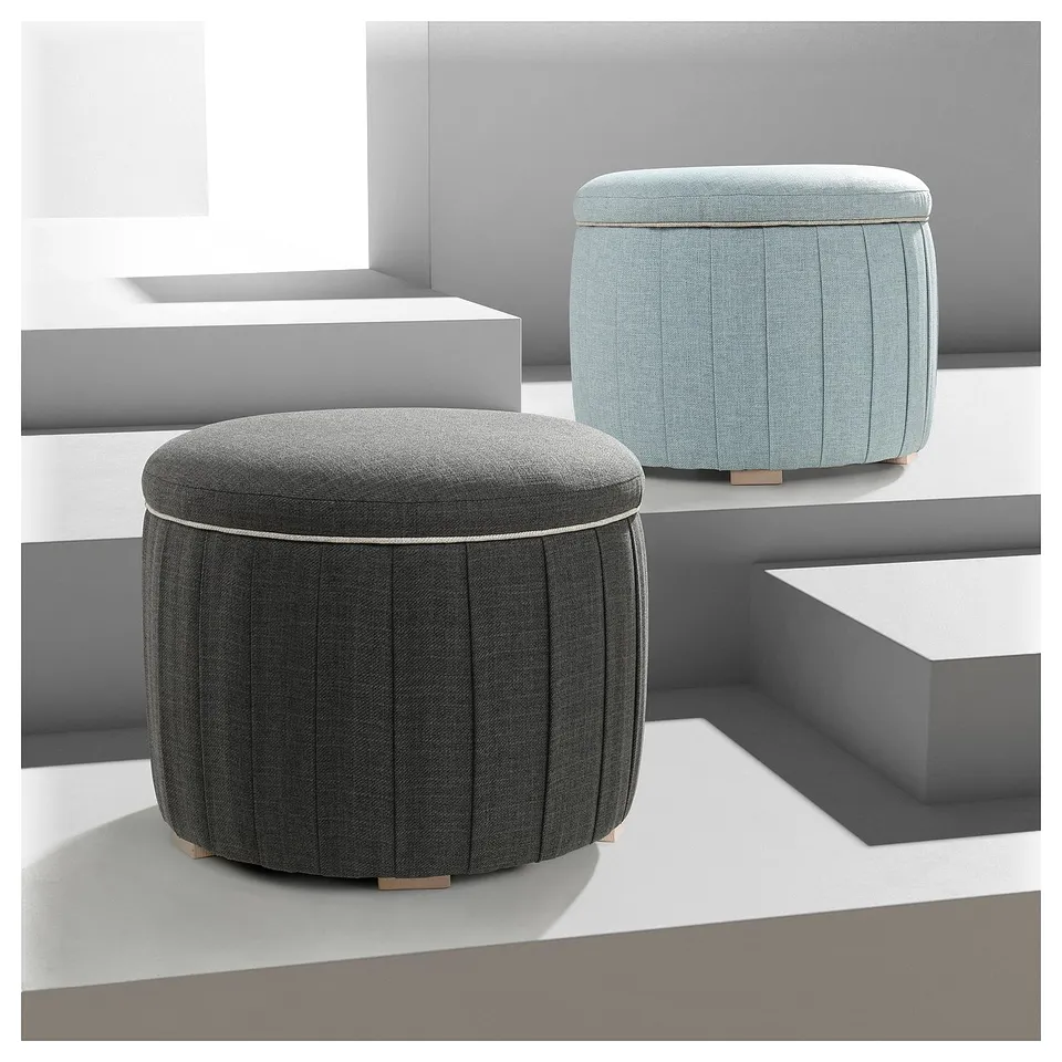 Two round, upholstered stools with pleated design. One grey, one light blue. Perfect for seating and storage.