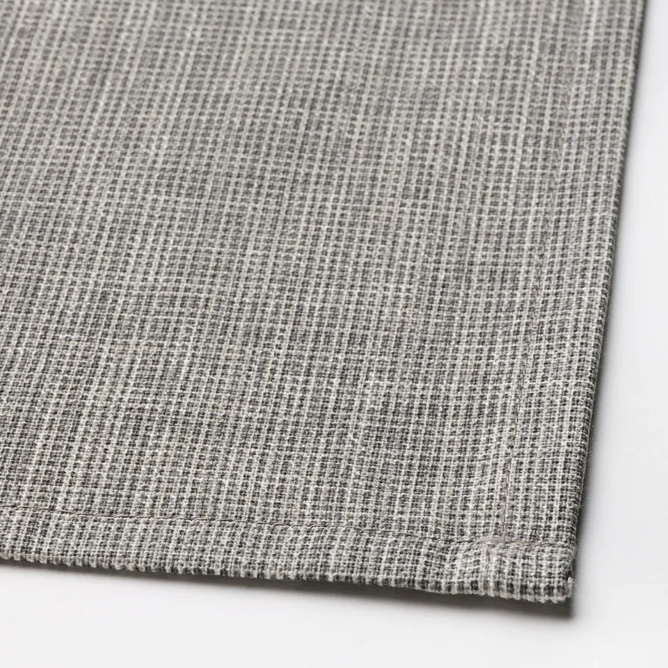 Close-up of a textured, grey tablecloth with intricate weave pattern.