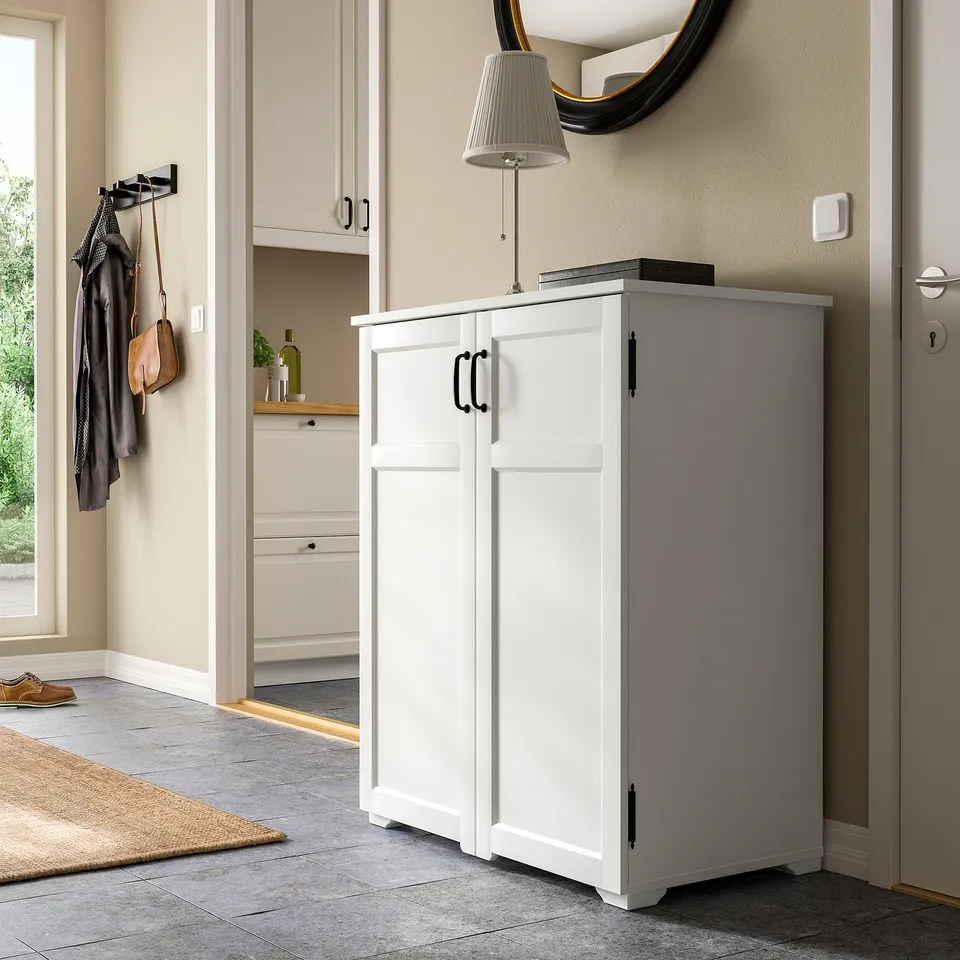White GREÅKER cabinet in hallway with 2 doors, lamp, and wood details.