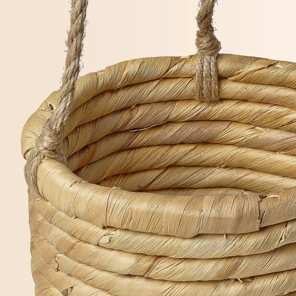 Handmade woven basket with sturdy jute handles, crafted from natural sedge and water hyacinth.