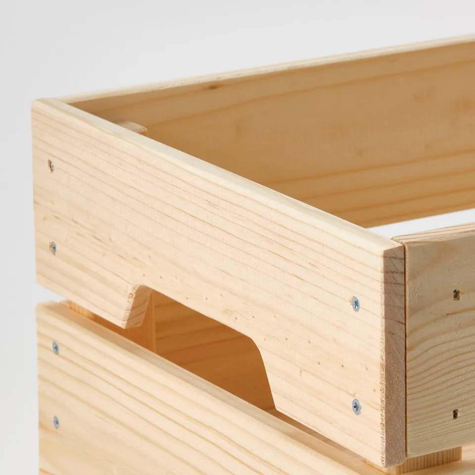 Stacked wooden storage boxes with cutout handles, showcasing natural, unfinished pine and sturdy construction.