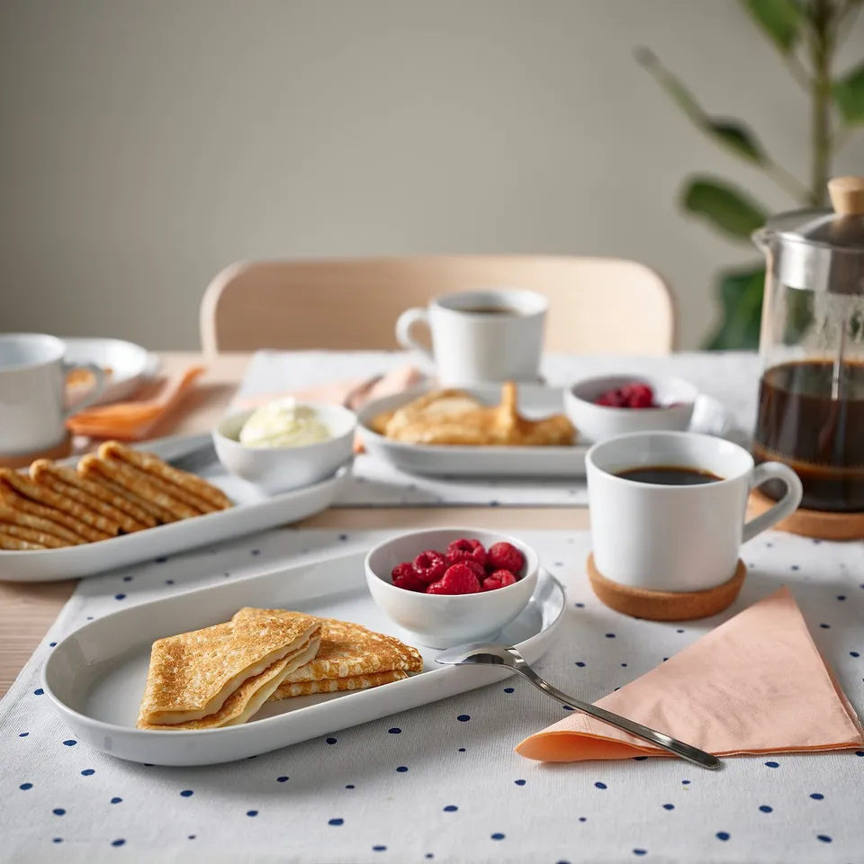 White ikea dish set with pancakes & berries, stackable coffee cup.