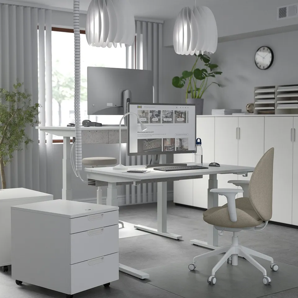 Modern home office: MITTZON white sit/stand desk, ergonomic chair, dual monitors, minimalist decor.