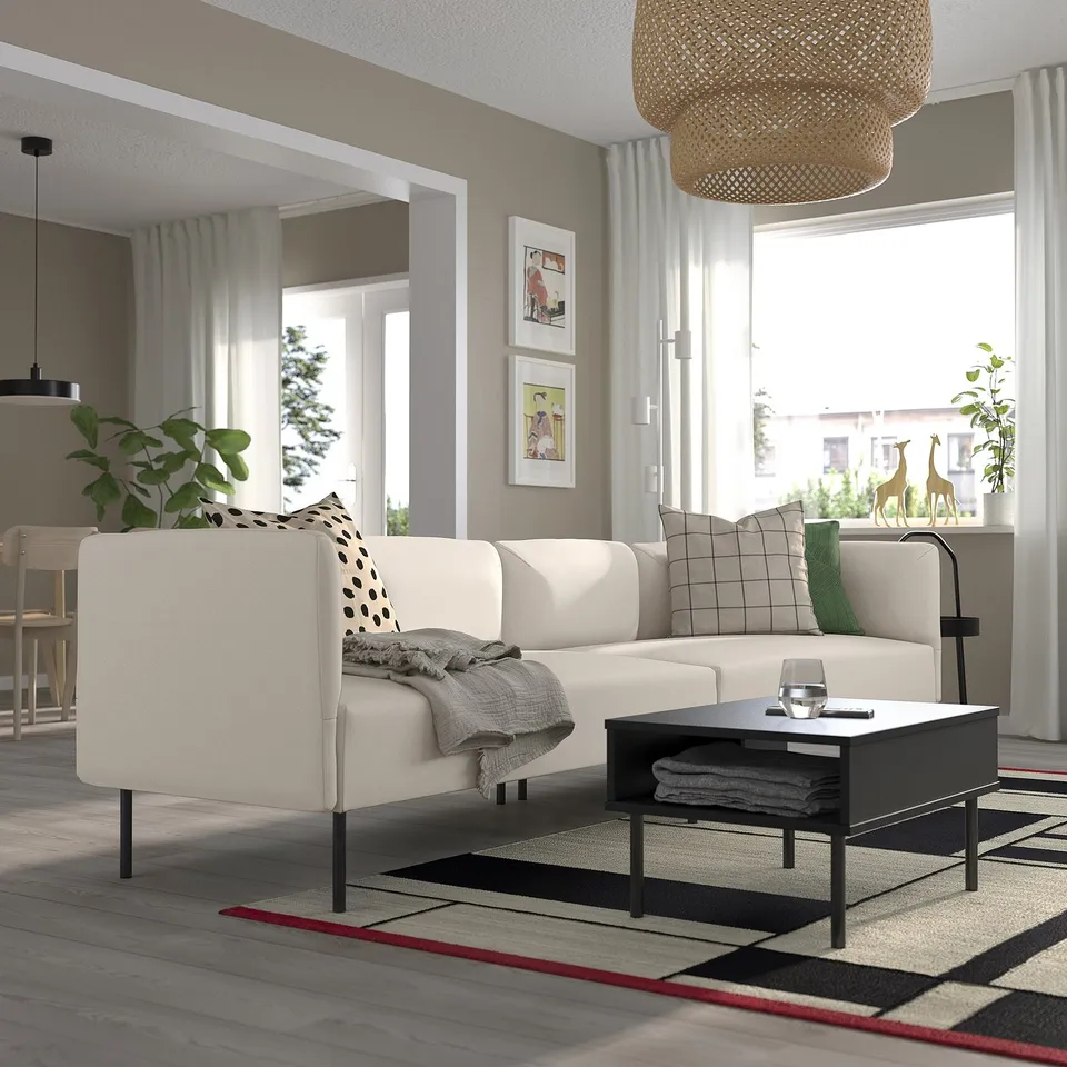 Modern living room with LILLEHEM sofa, coffee table, rug, and large windows.