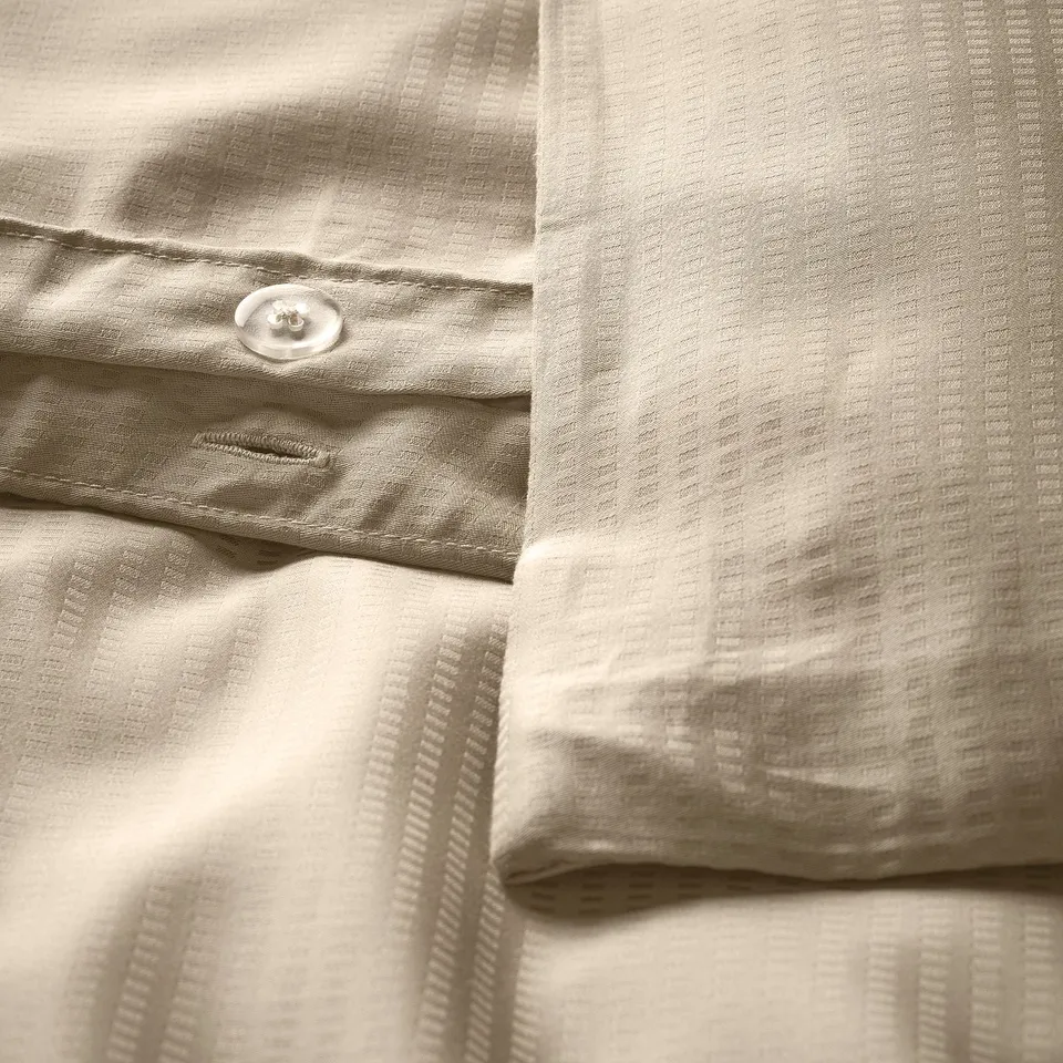 Beige dobby duvet set with flanged pillowcase and silky fabric.