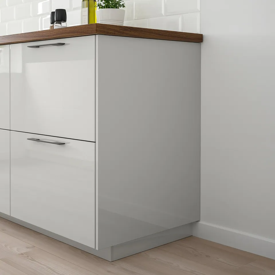 Modern kitchen with glossy yellow RINGHULT cabinet, sleek and reflective, neat and minimalist.