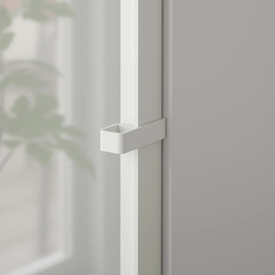 White metal handle on glass door, securely attached showing durable design.