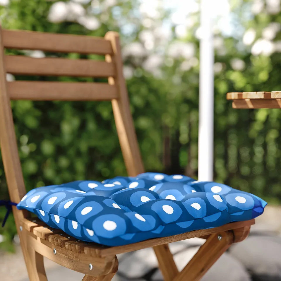 Wooden chair with blue and white patterned cushion.