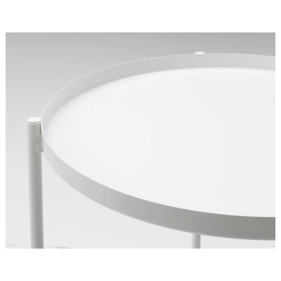 Modern circular side table with sleek, metallic tray top. Two slender stems support the base, exuding contemporary elegance.
