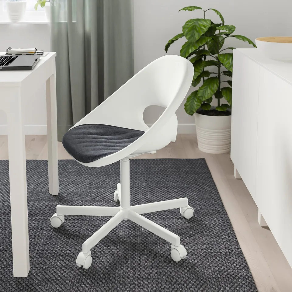 PYNTEN chair next to desk with laptop and plant.