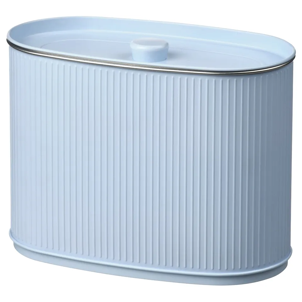 A blue BETTHAJ container. Its cylindrical, made of tin-plated steel, with a ribbed design, and a lid with a small handle.