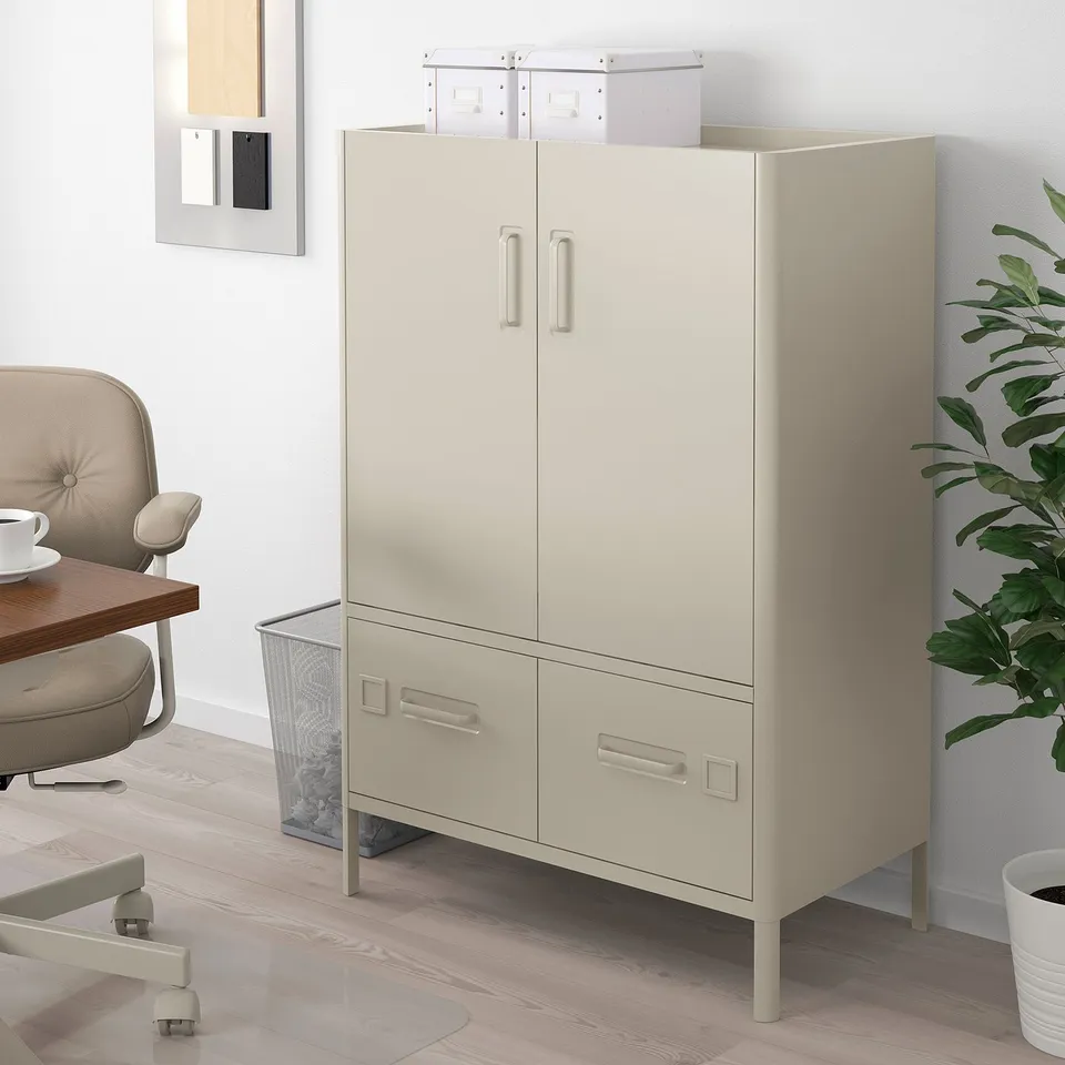 IDÅSEN beige storage cabinet, fits in office corner.