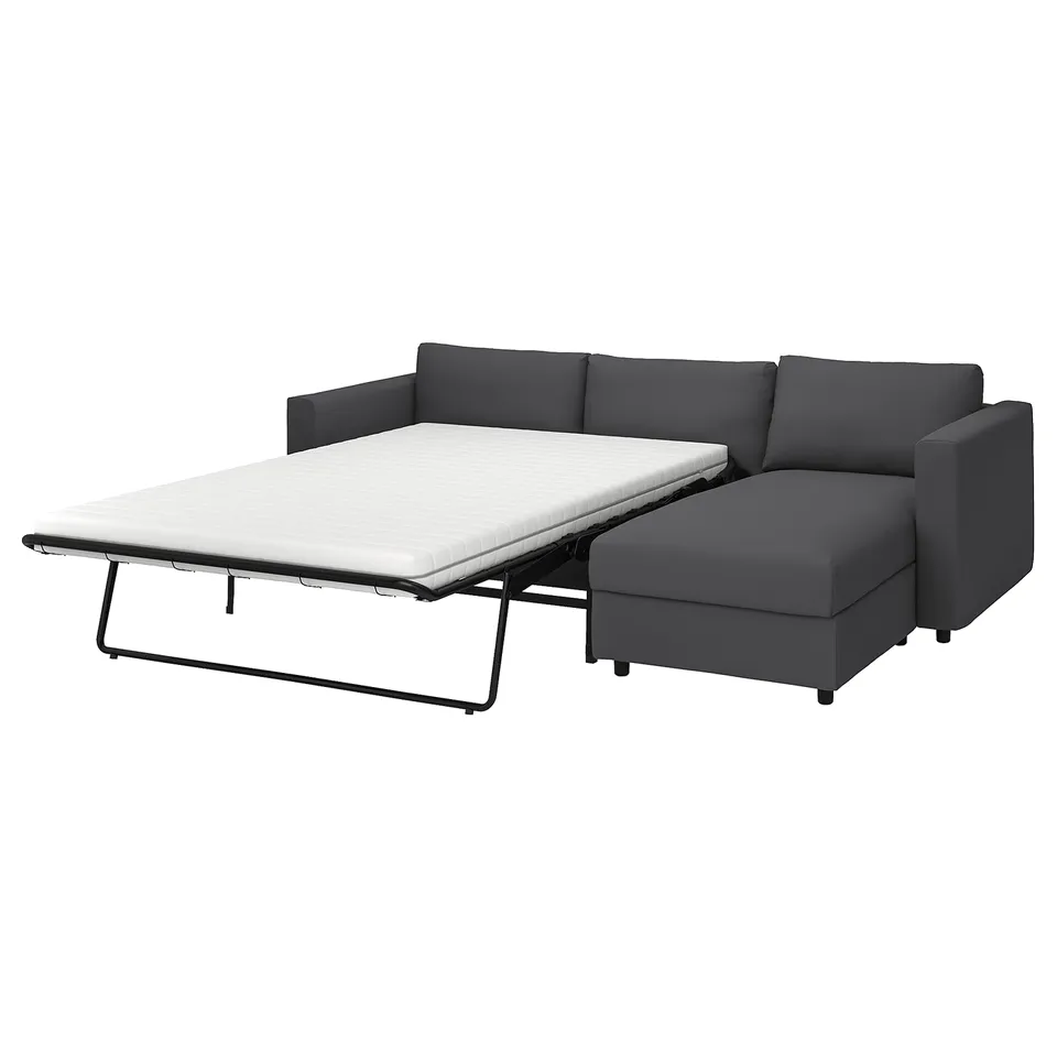 A grey VIMLE sofa-bed, l-shape convertible, with a removable, machine-washable cover and a thick mattress for comfortable sleeping.