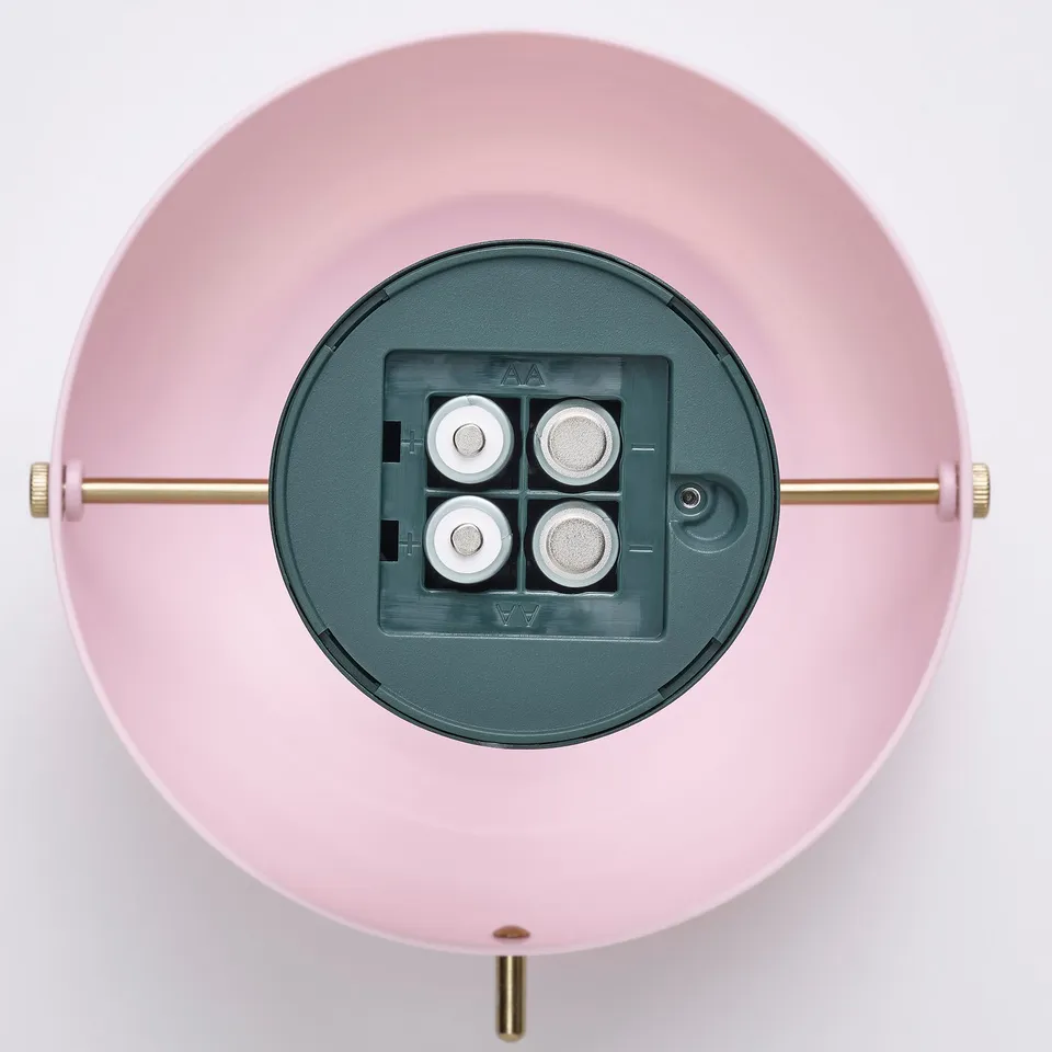 Image depicts a pink, battery-powered led lamp with a usb-c charging port, holding four rechargeable batteries.
