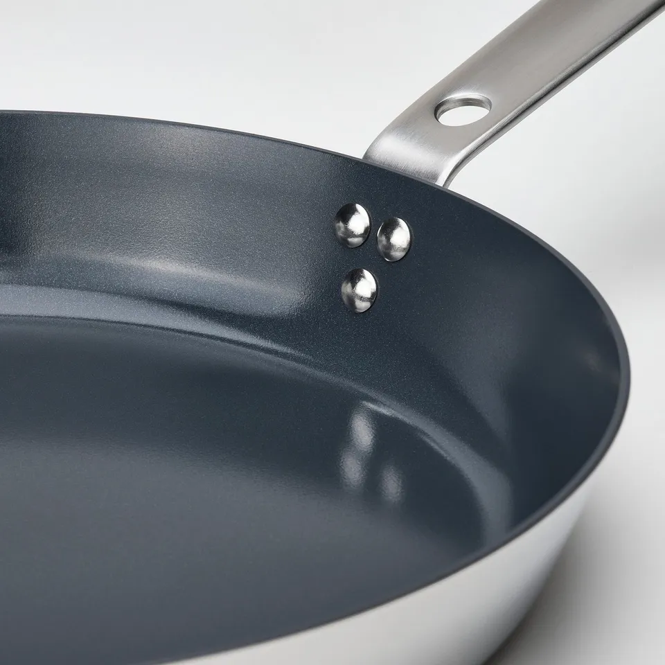 Close-up of a frying pans non-stick surface and handle.