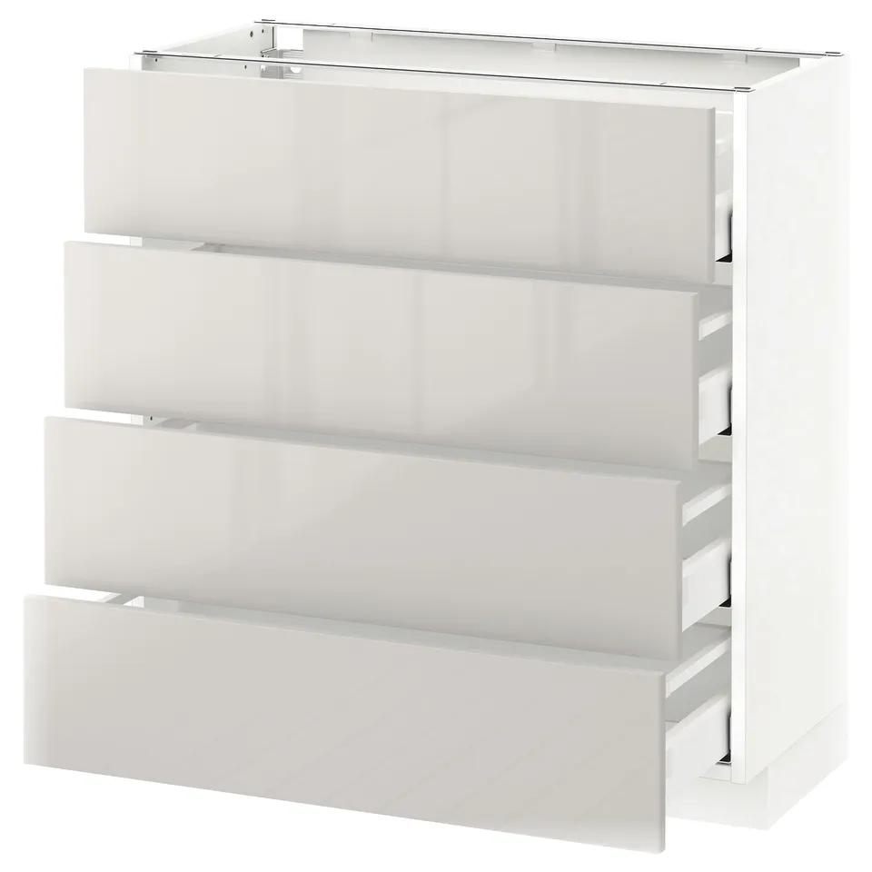 White METOD kitchen cabinet with four grey drawers, glossy finish.