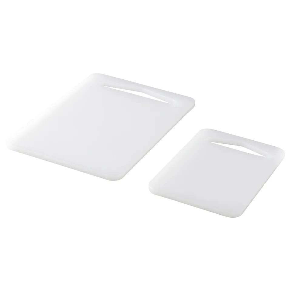 Two white plastic chopping boards, rectangular with slightly flared edges, placed separately against a white background.