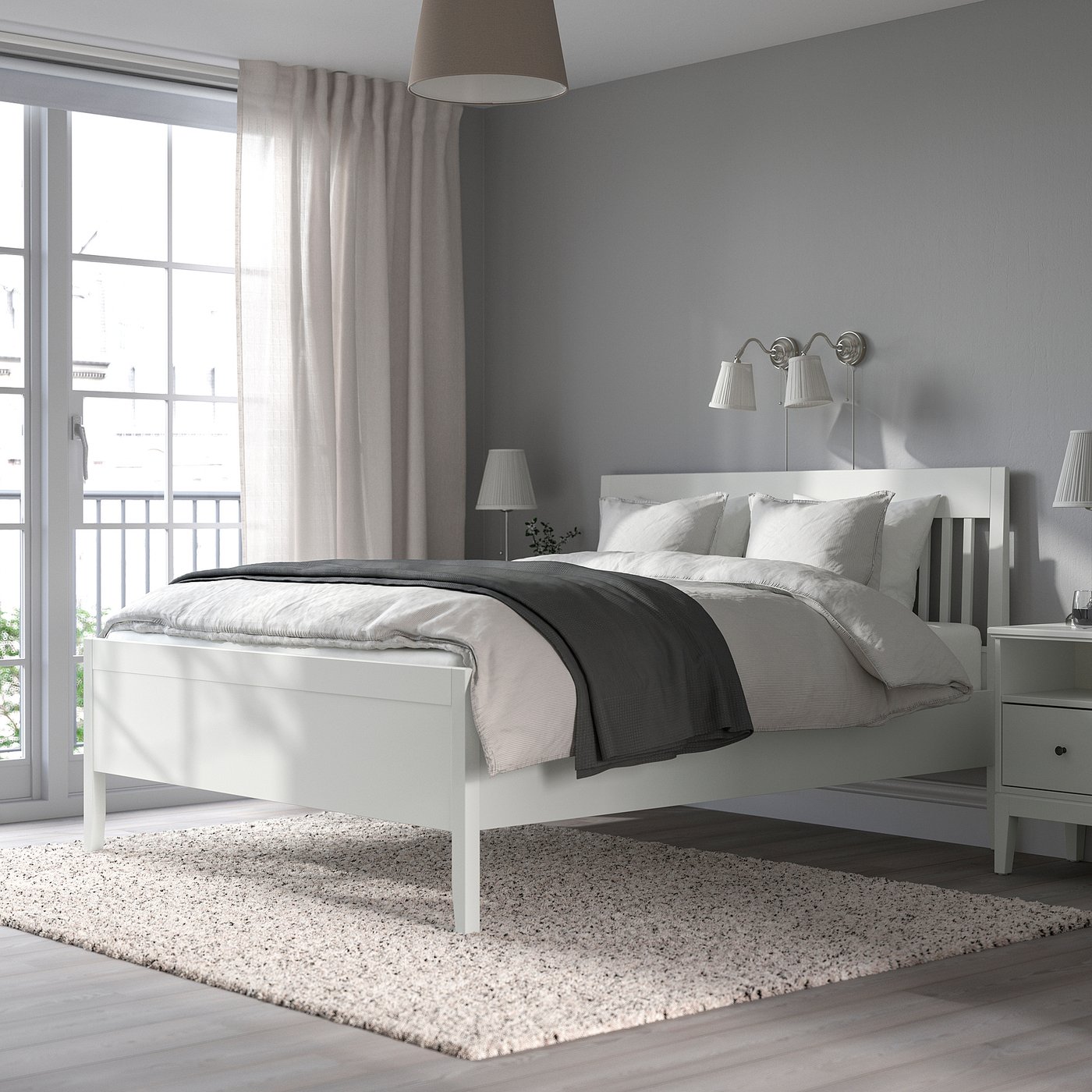 IDANÄS white bed with grey bedding in a serene bedroom setup.