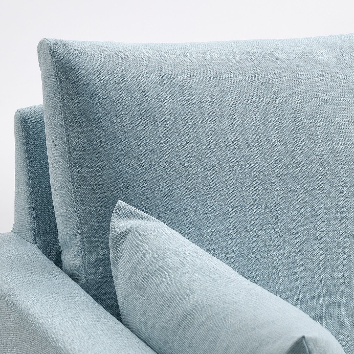 Light blue fabric sectional sofa, clean modern design, comfortable padding, showcasing quality craftsmanship.