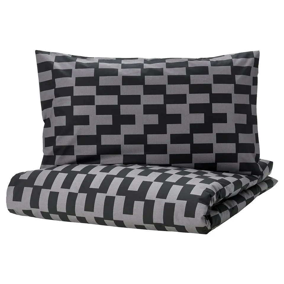 Black and grey pixelated bedding set with a duvet cover and pillowcase. Modern geometric pattern, soft cotton blend fabric.