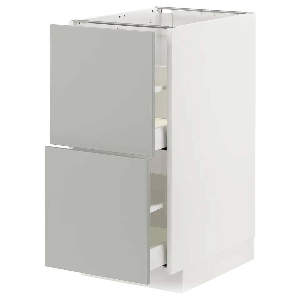 Modern white kitchen cabinet with grey drawers and door. Minimalist design, two accessible drawers, smooth finish.