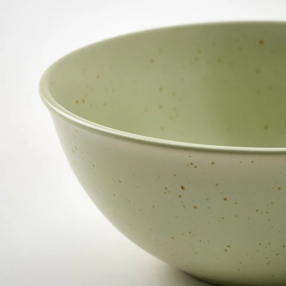 Green speckled bowl, smooth matte finish, wide rim.