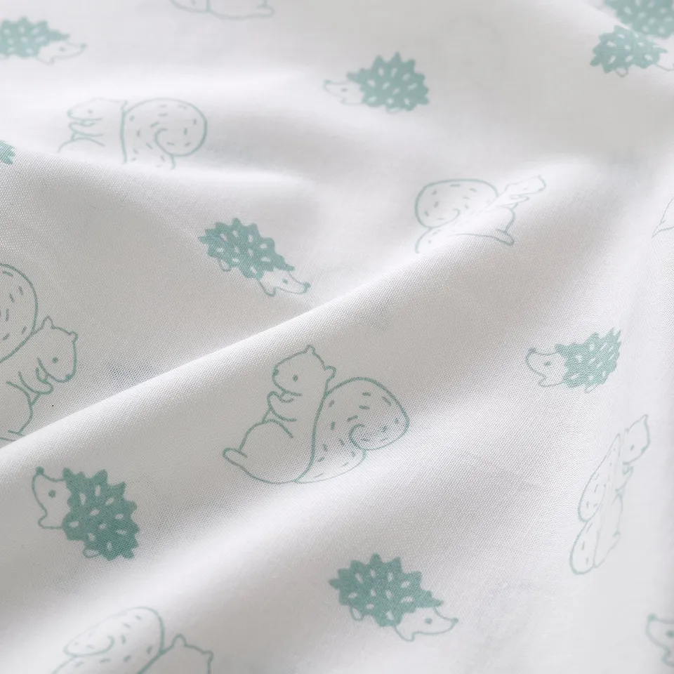 A lightweight, soft fabric with a patterned design of green squirrels and hedgehogs on a white background. Suitable for childrens textiles.