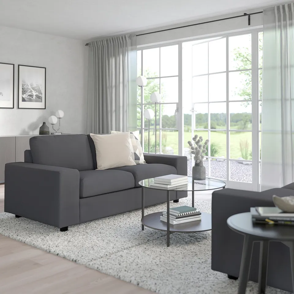 Modern living room with VIMLE grey sofa, large windows, and cosy decor.