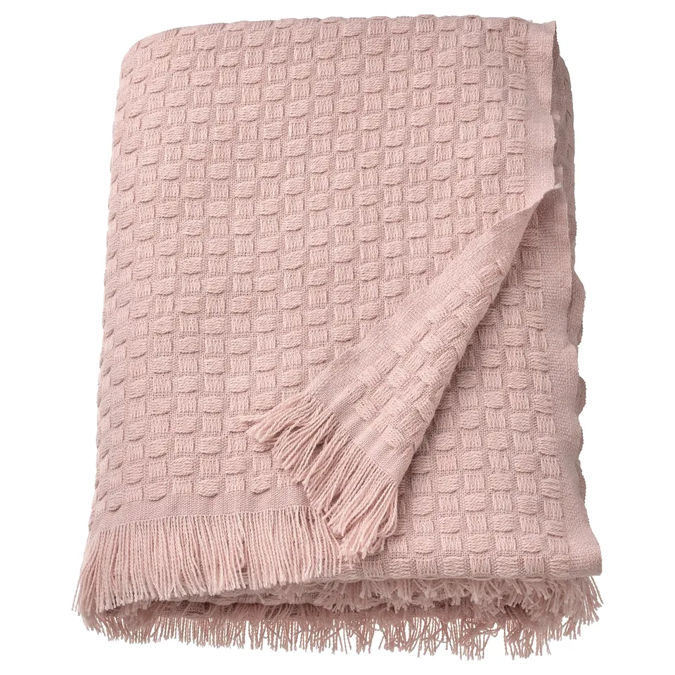 Light pink HORNMAL throw, soft & fluffy, woven texture, fringe edges.