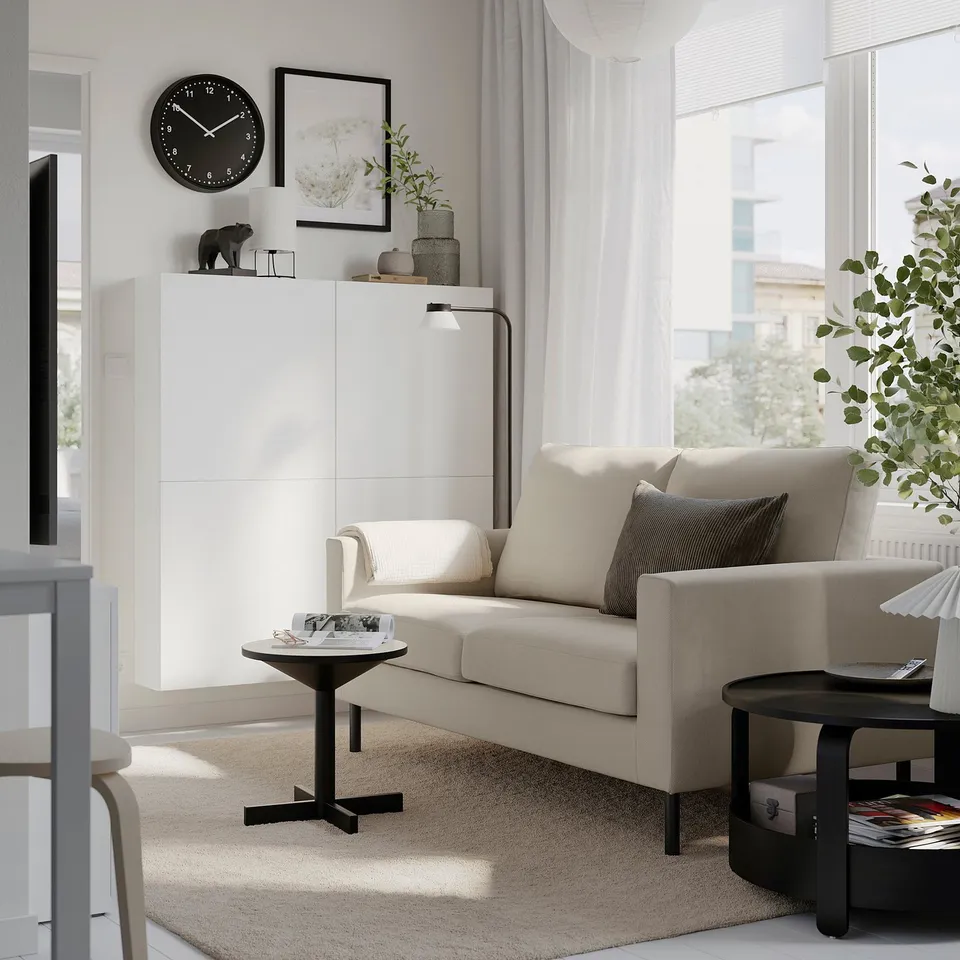 A modern living room with a white SALTSJÖBADEN sofa, which looks cosy and well-proportioned compared to surrounding decor.
