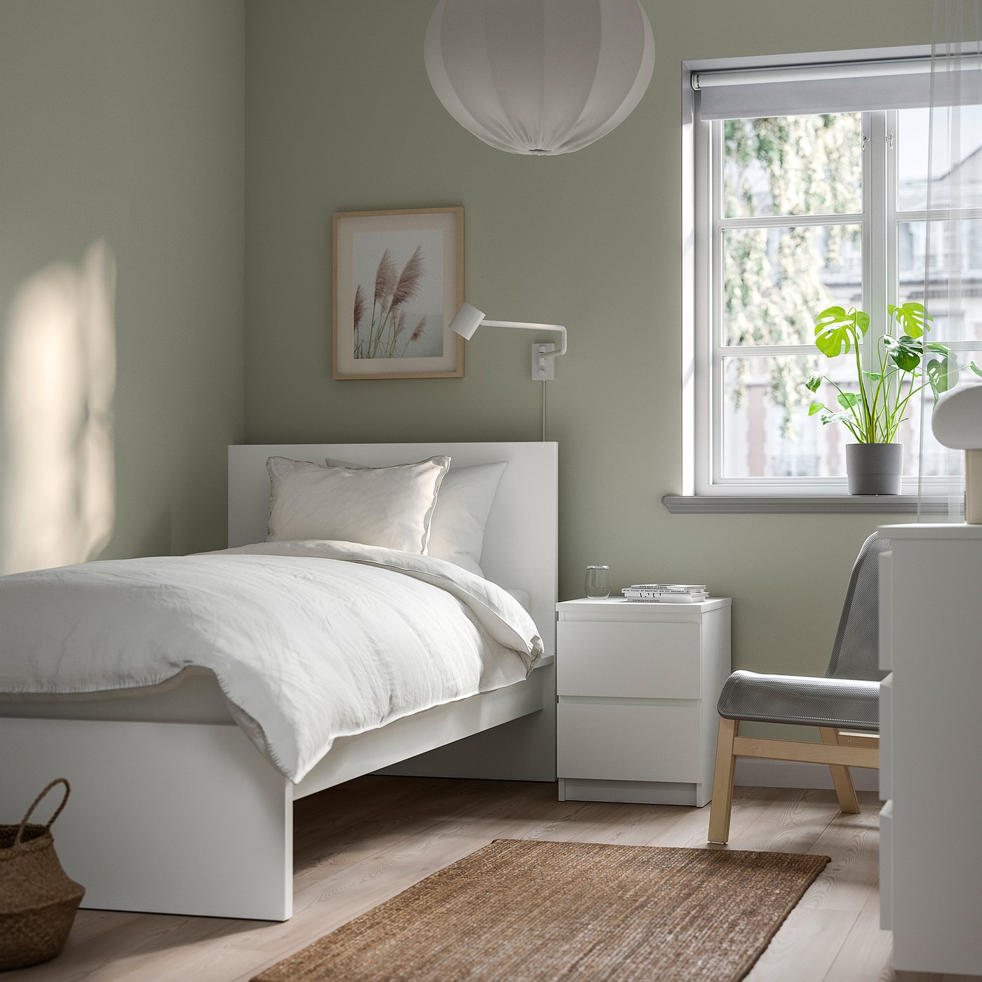 Sage green bedroom with MALM bed, bedside table, rug, chair, plant, curtains, print
