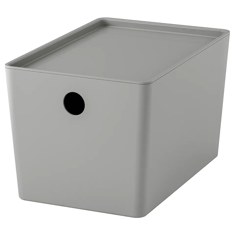 A grey KUGGIS storage box with a round handle on one side. Its made of recycled pet plastic and a lid for dust protection.