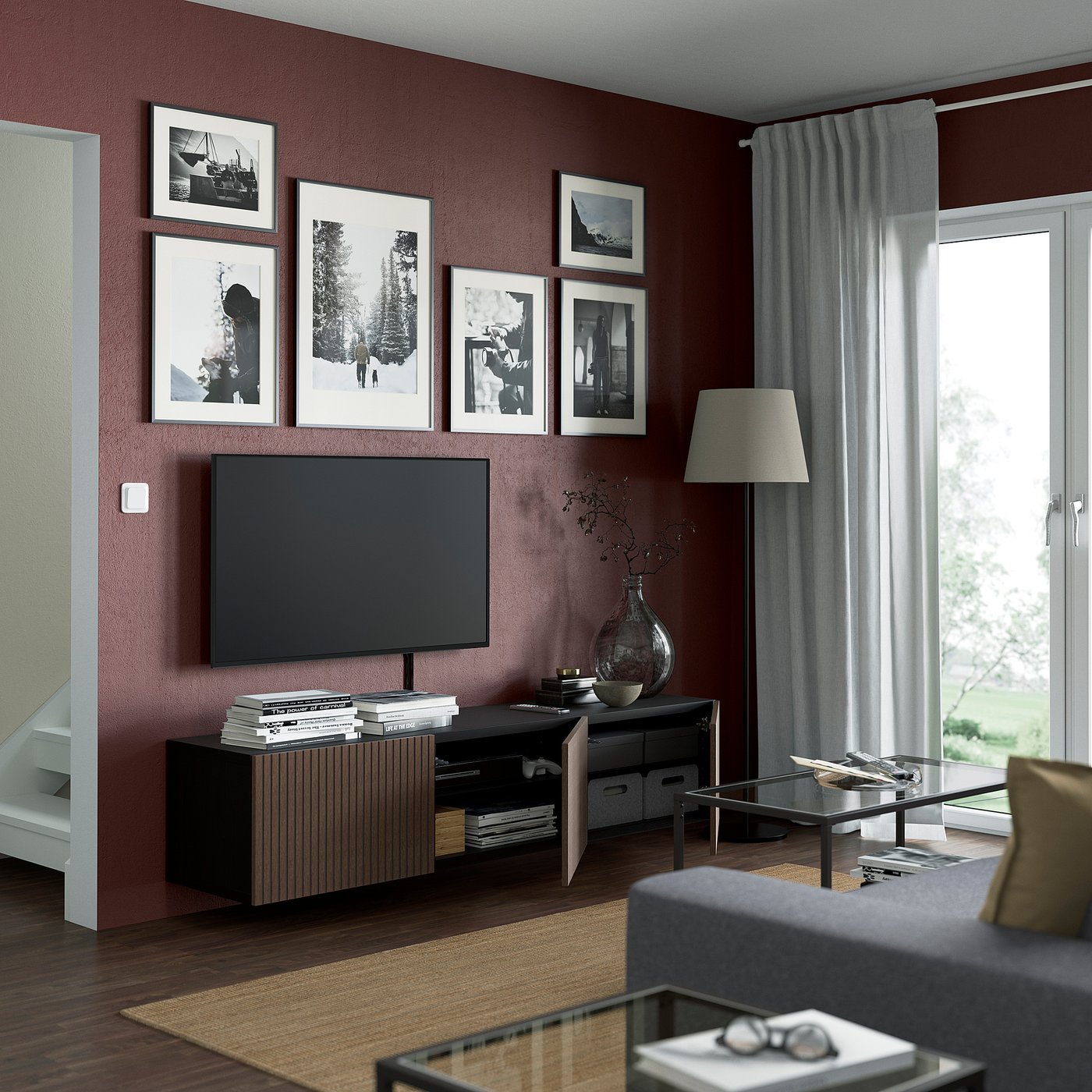 Modern maroon living room with BESTÅ tv bench, flat screen, and glass coffee table.