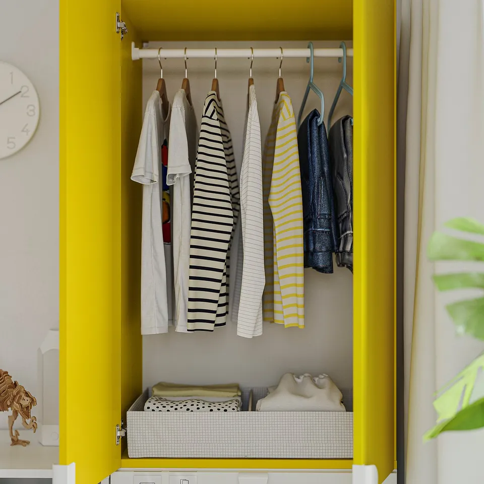 A yellow wardrobe with clothes hung neatly. The wardrobe shelves and organiser boxes for storage.