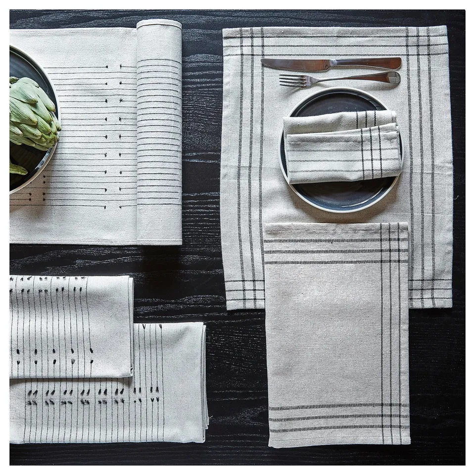 The VÅRARV place mat set in neutral colours a textured design made from cotton and jute, perfect for setting a rustic table.
