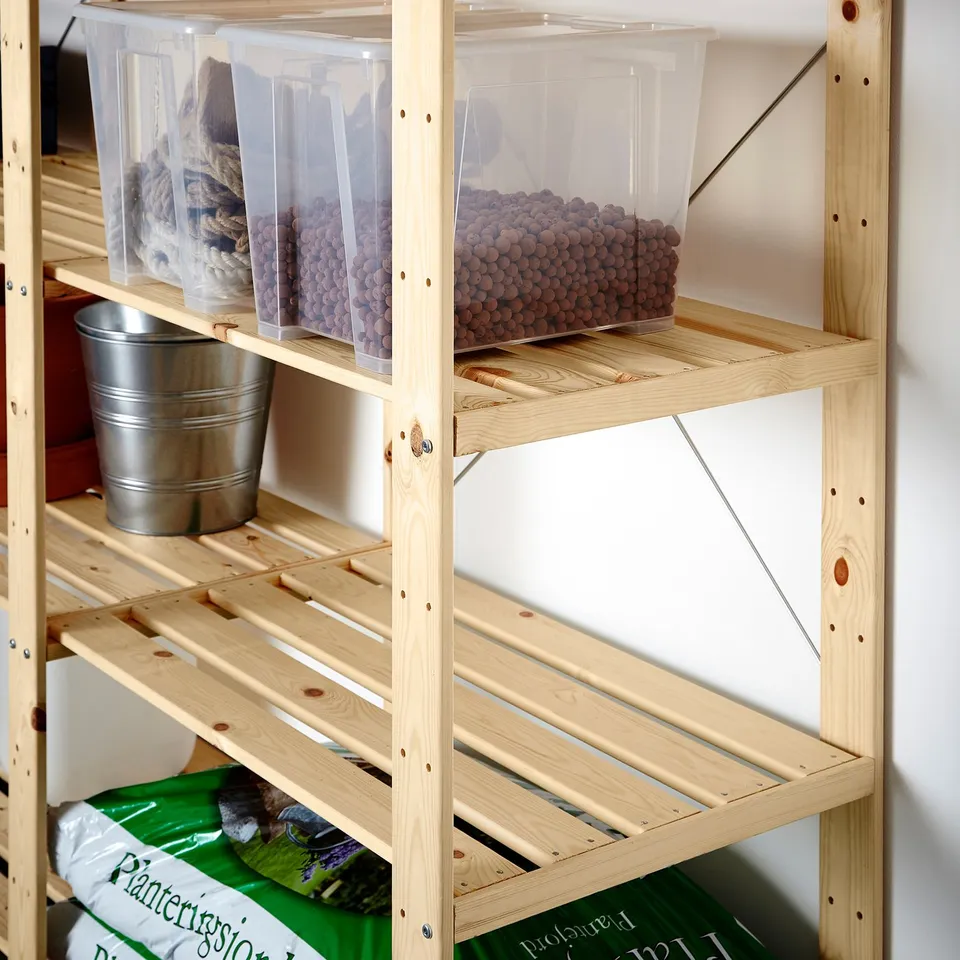 Wooden storage shelves with clear bins and buckets, holding various items.