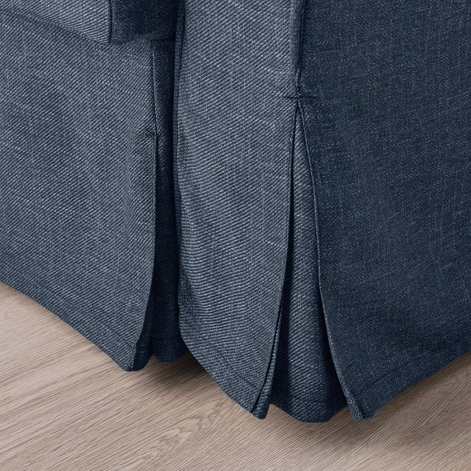 Close-up of VRETSTORP sofa-bed, showcasing durable, dark fabric with subtle texture, pleated edges, and clean stitching.