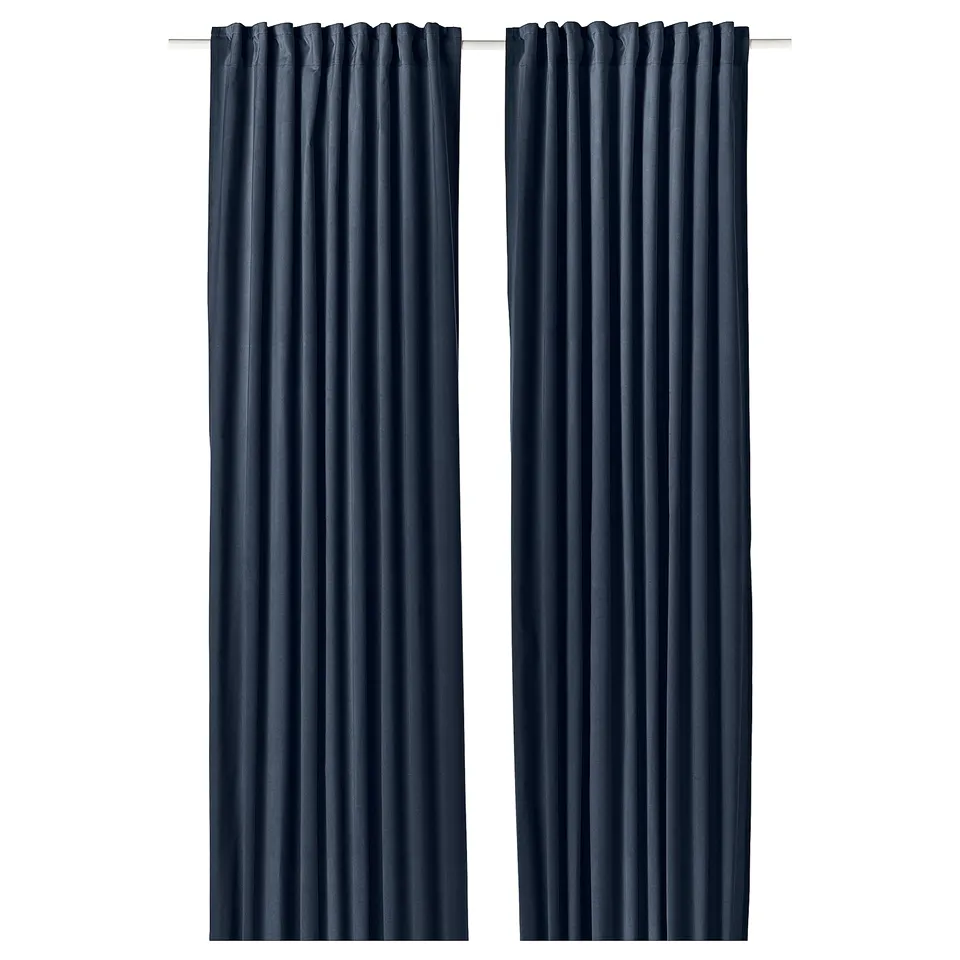 Two dark blue velvet SANELA curtains hang side by side, featuring a room-darkening design and multi-way header.