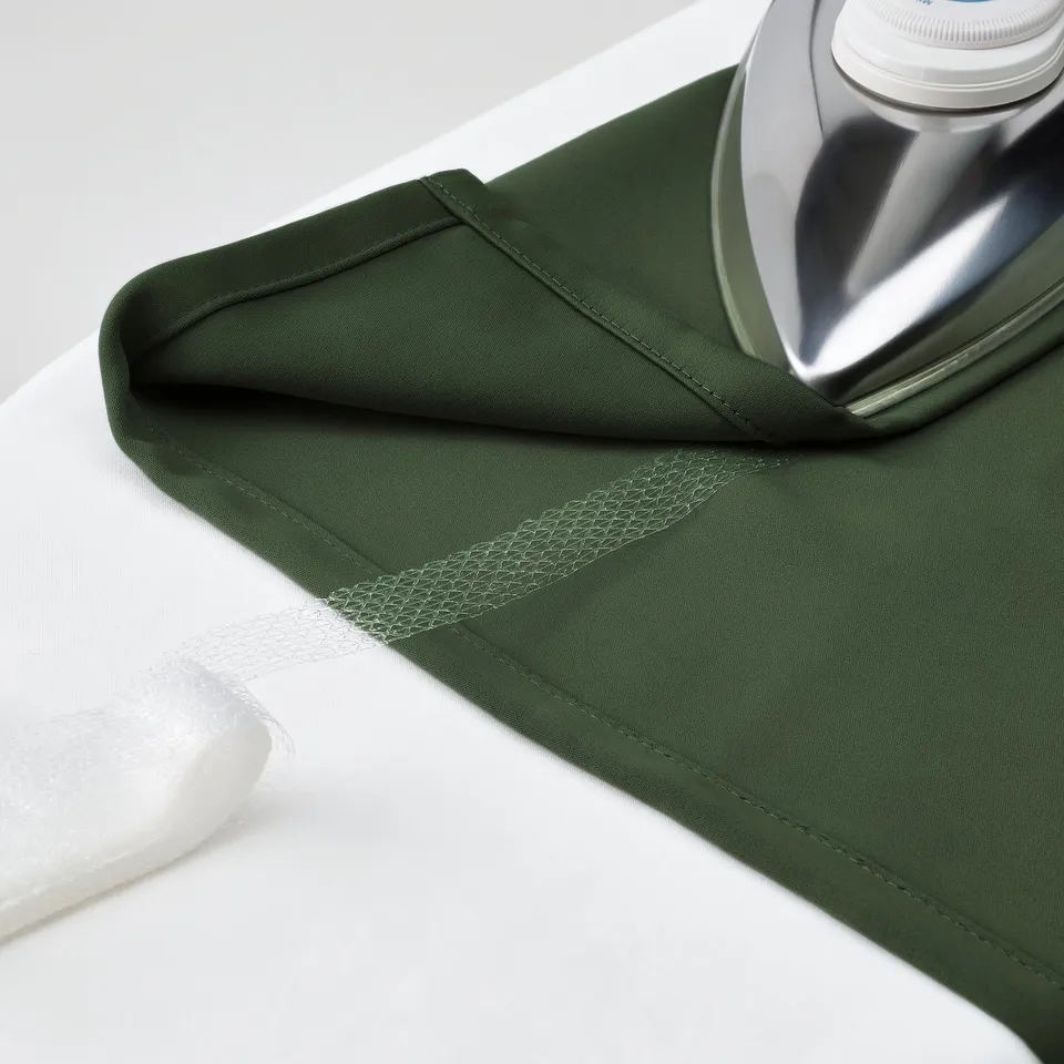 Green curtain ironed with silver iron for smooth look.