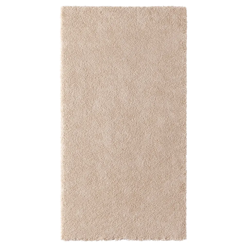 A beige-colored STOENSE rug with a soft, thick pile. Its rectangular and made from polyester and polypropylene, perfect for bedrooms.