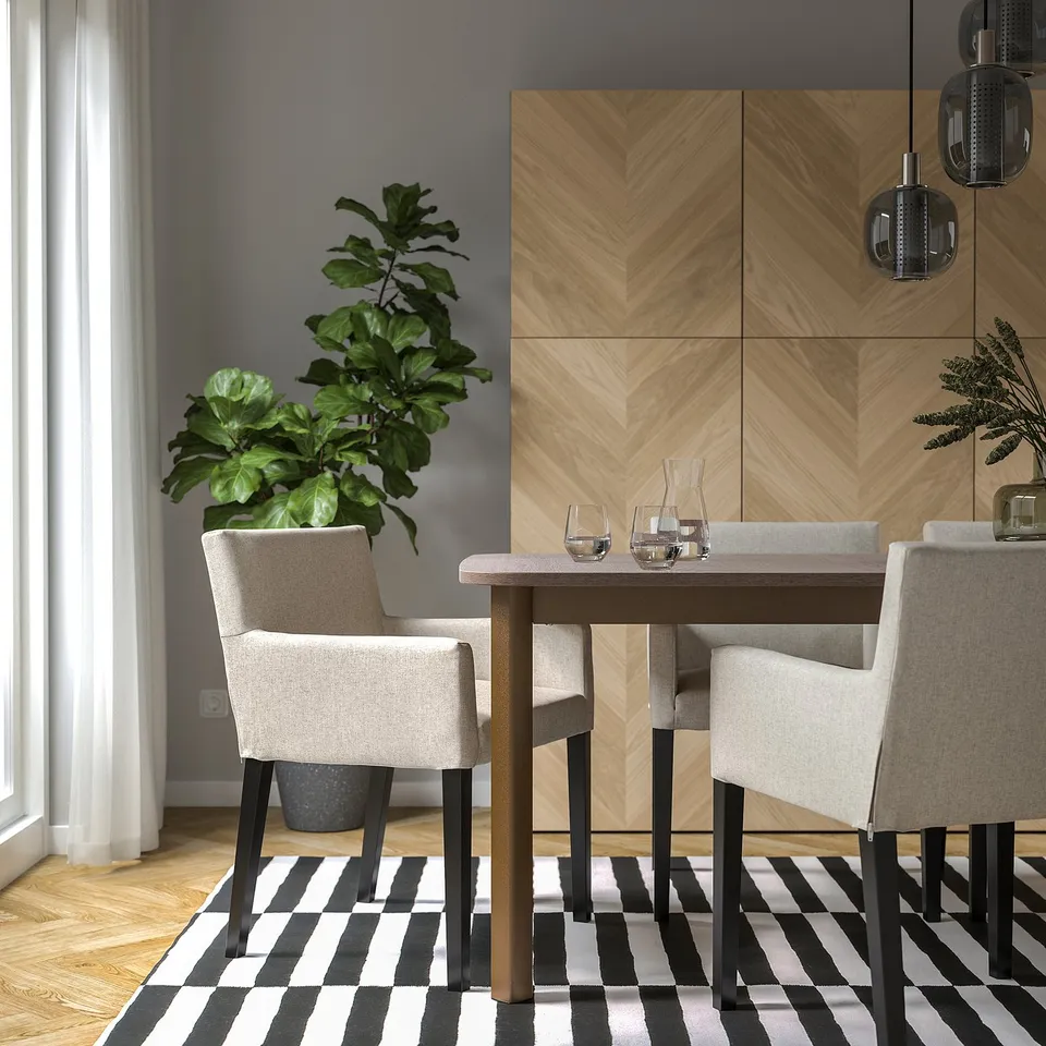 Modern dining area with MÅRENÄS chair, wood table, rug, plants, cleanable fabric.