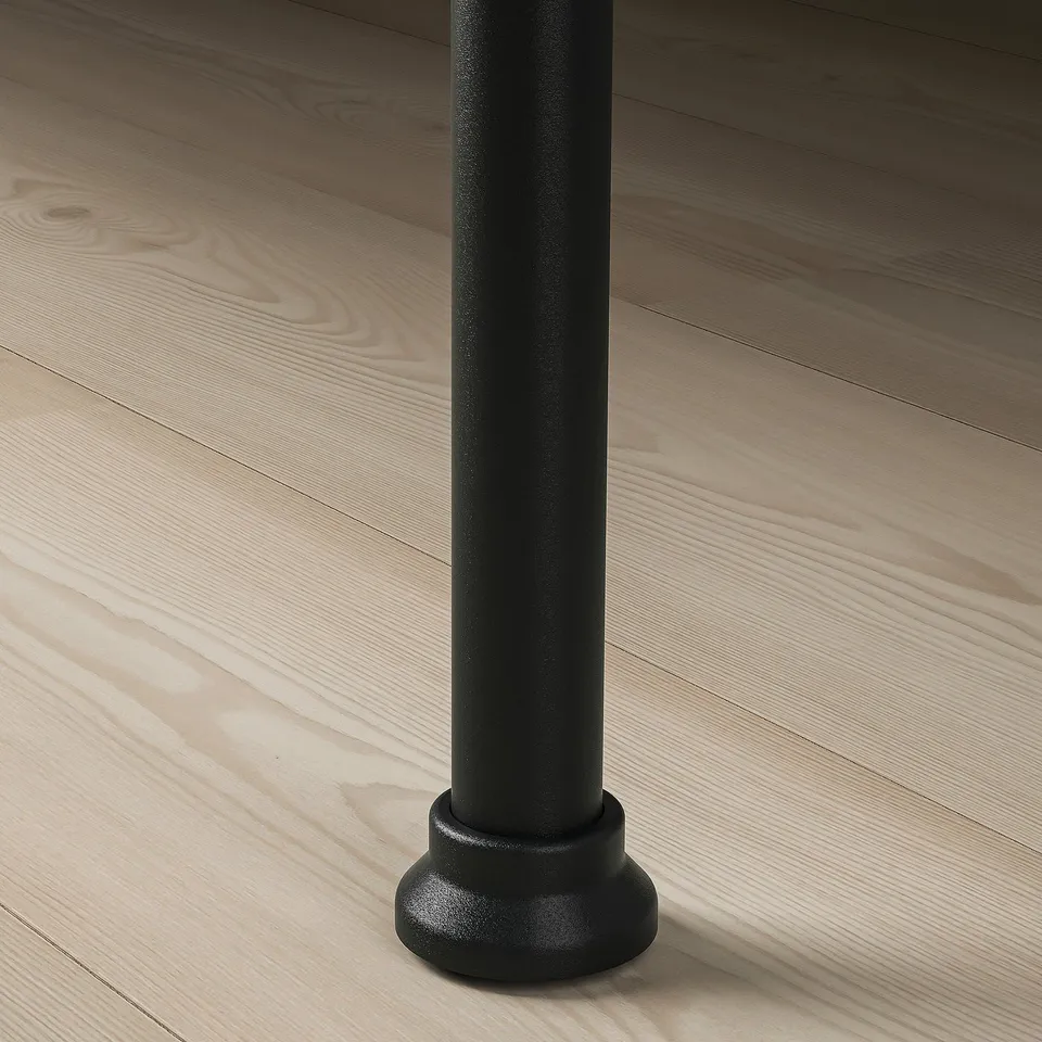 Close-up of a modern bed frame leg, smooth black finish, sturdy and stylish.