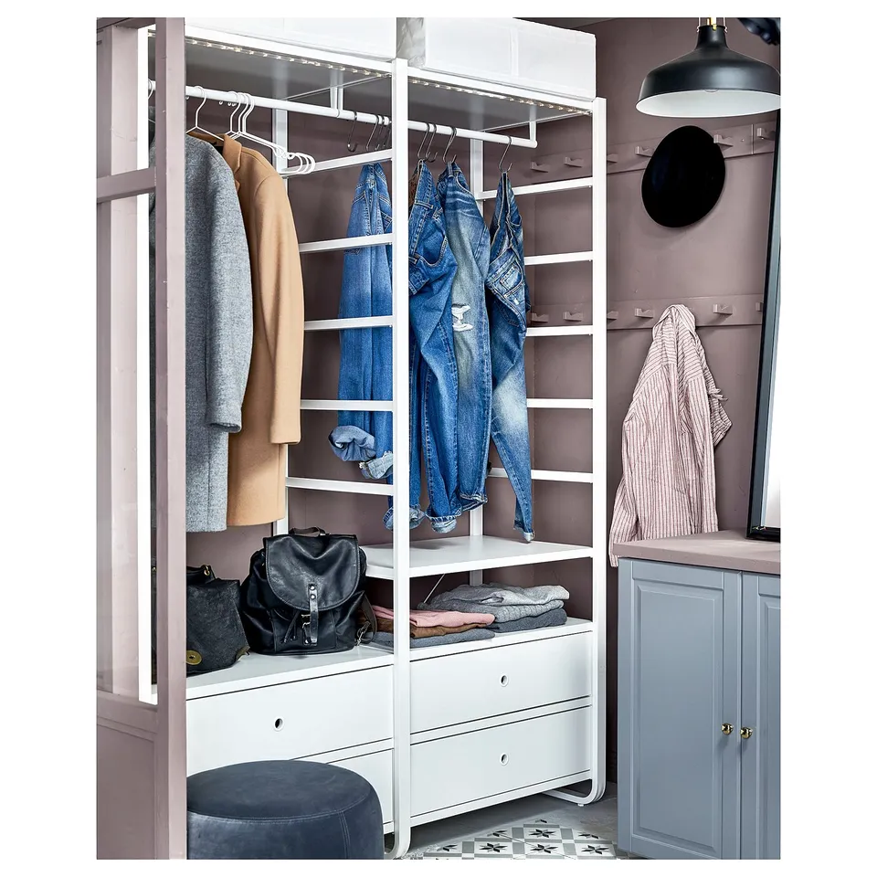 ELVARLI white metal clothes storage, hanging jeans and coats, grey drawers, grey wall.