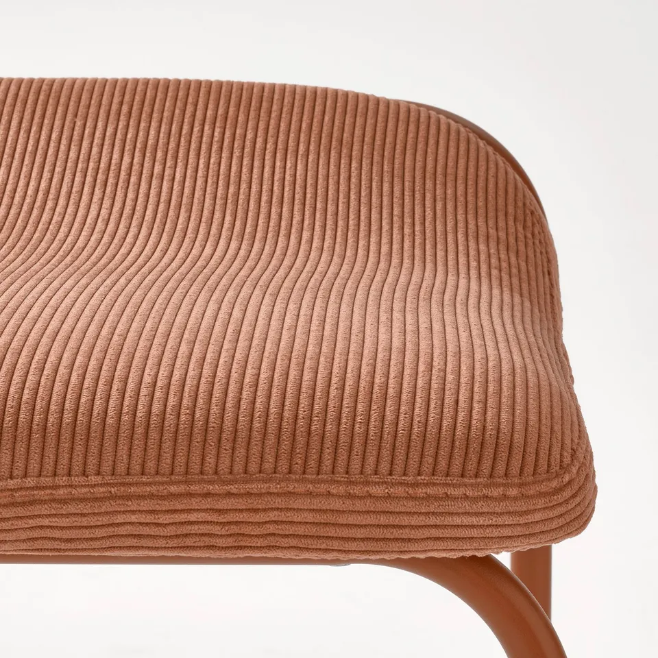 Close-up of a KESNACKEN bar stool seat in rust corduroy, showcasing soft, durable fabric and comfortable design.